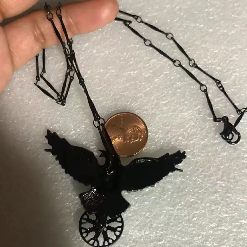 Black raven pendant necklace with black link chain.